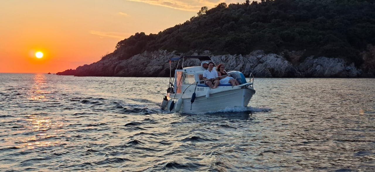 Big Blue boat carrying guests along the evening coast
