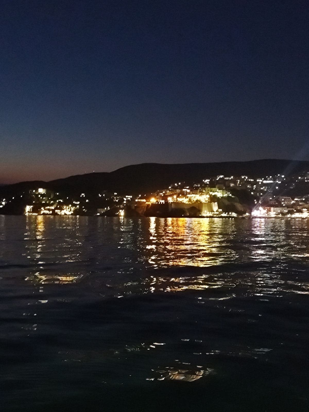 Harbor lights under a deep blue dusk sky
