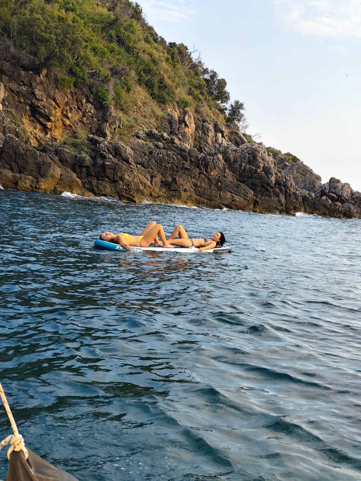 Guests floating under the cliffs near Ulqin