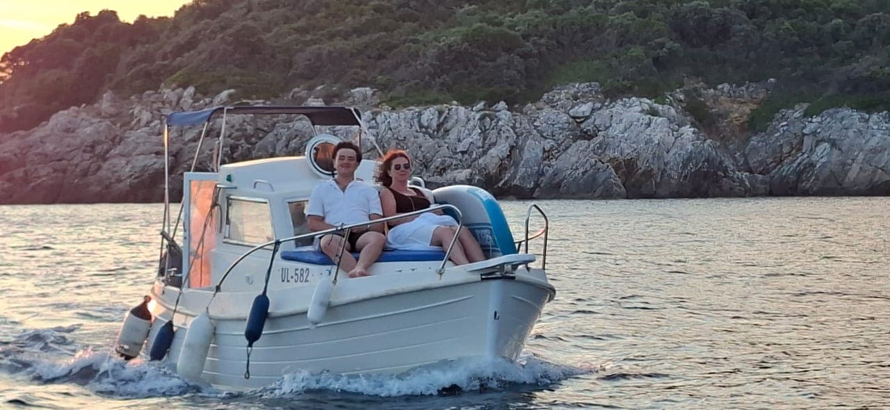 Guests aboard Big Blue beside the rocky coast
