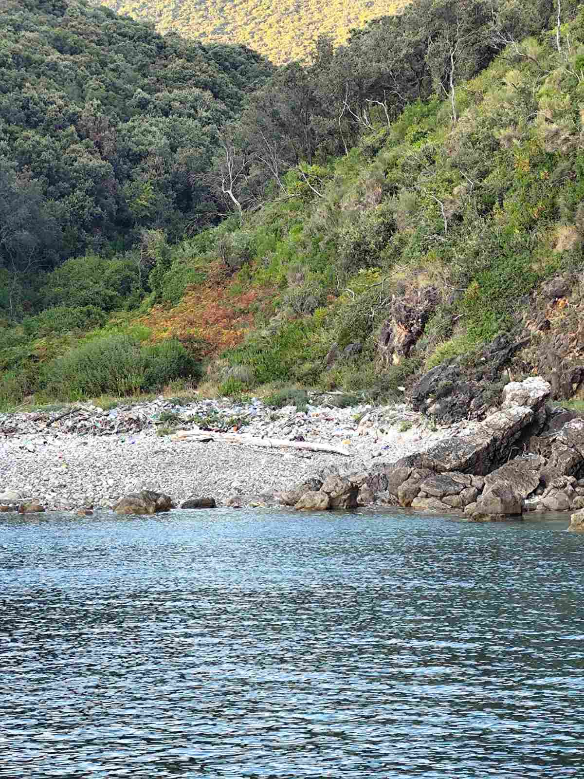 Hidden beach with clear water and rocky shore